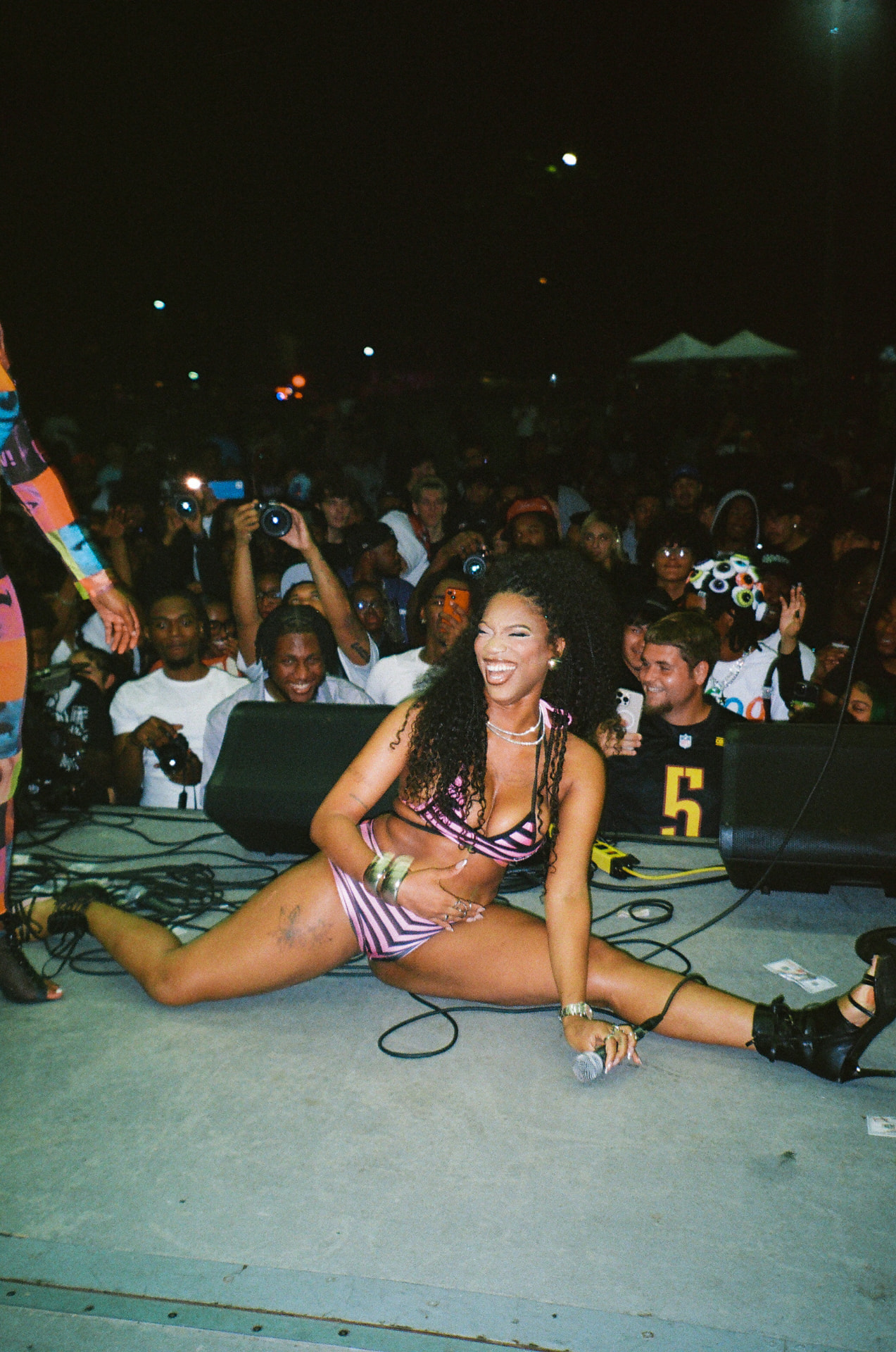 A joyful performer sharing a close community moment at the festival